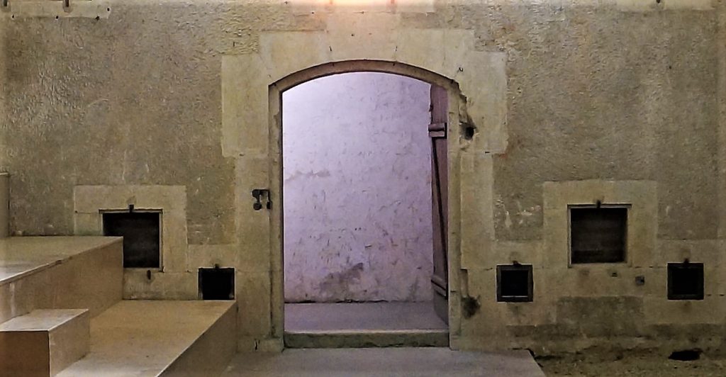 Le mur de la chambre aux poudre montre au centre l'ouverture de la porte d’accès. Sur le bas du mur, on observe les baies d'aréage de la chambre.