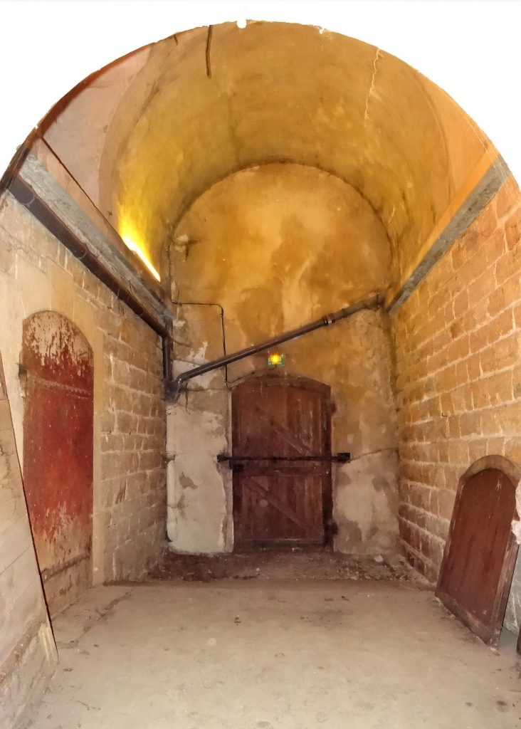 Le vestibule du magasin à poudre présente une porte qui s'ouvre sur l’extérieur et une porte blindée qui défend l’accès à la chambre de stockage.